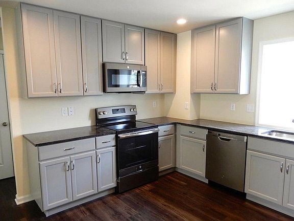 Large kitchen with GE stainless steel appliance with granite counter tops