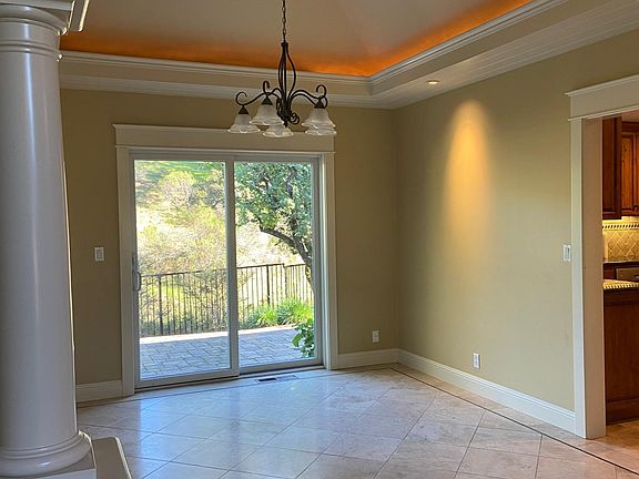 Dining room with coffered ceiling and custom mood lighting.