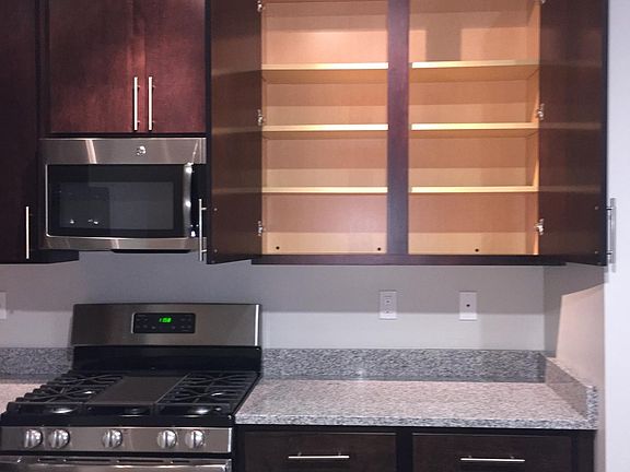 This home offer 42" cabinets with brushed nickel handles for a ridiculous amount of food/dishware storage.