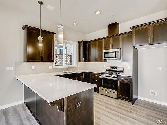 Kitchen. Photo is of Unit A. Same floorplan, similar features.