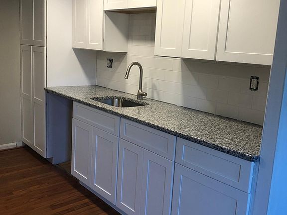 Kitchen with granite countertops & white shaker cabinets