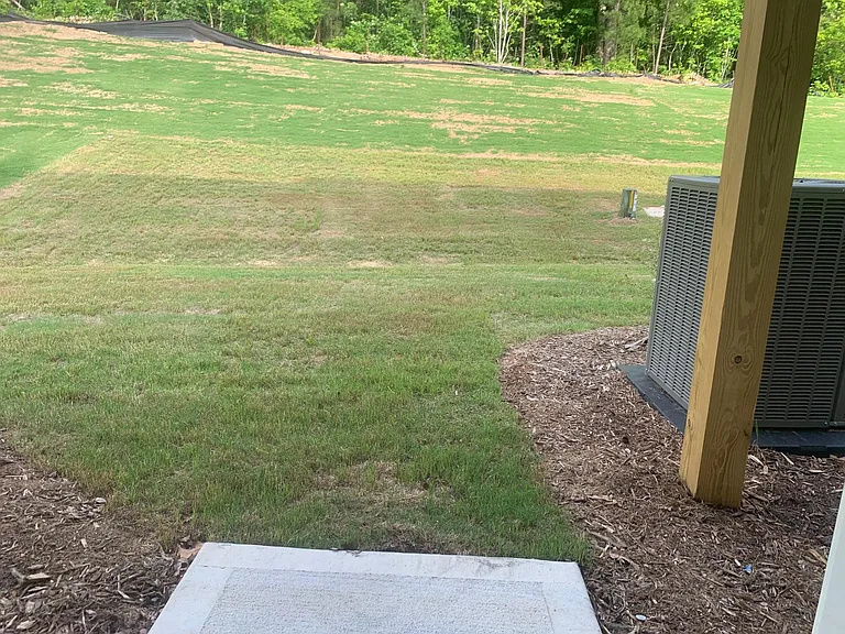 To Patio through first floor bed room that shows the backyard with privacy.