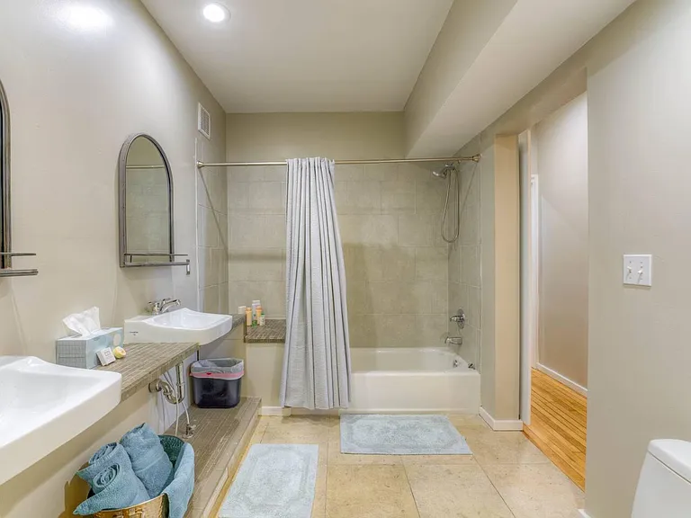 Primary bedroom ensuite bathroom with tub/shower combo and large walk in closet