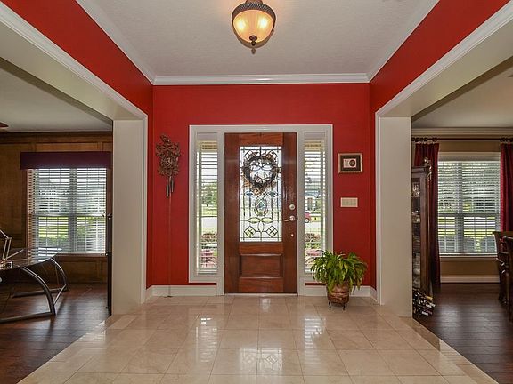 The leaded glass door opens to the Foyer with beautiful designer paint and marble flooring.