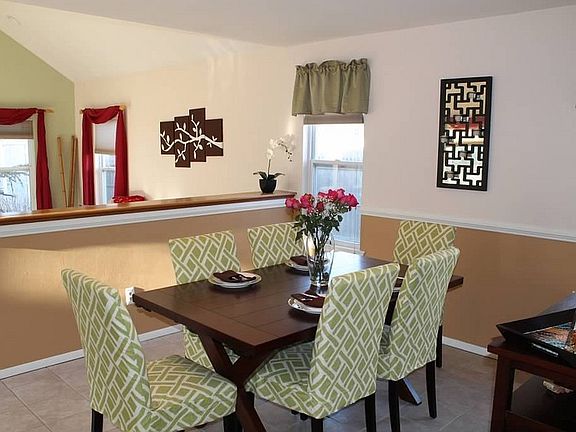 Dining Room : Featuring a half-wall looking into the family room
