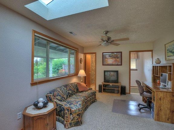 Family room just off the kitchen & dining area. Makes for GreatRoom living. Door to left is half bath. Door to right is laundry room. Again, skylights throughout.