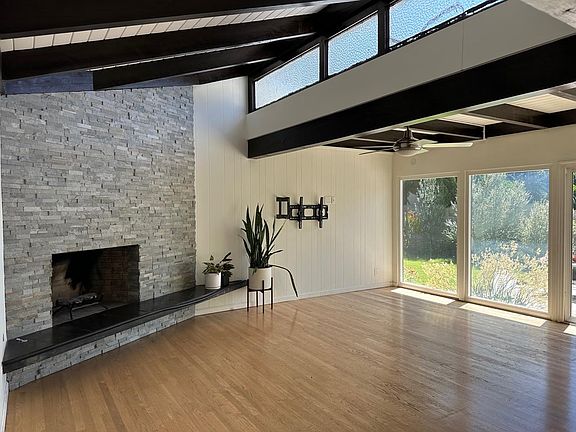 family room with gas fireplace and sliding door to private backyard