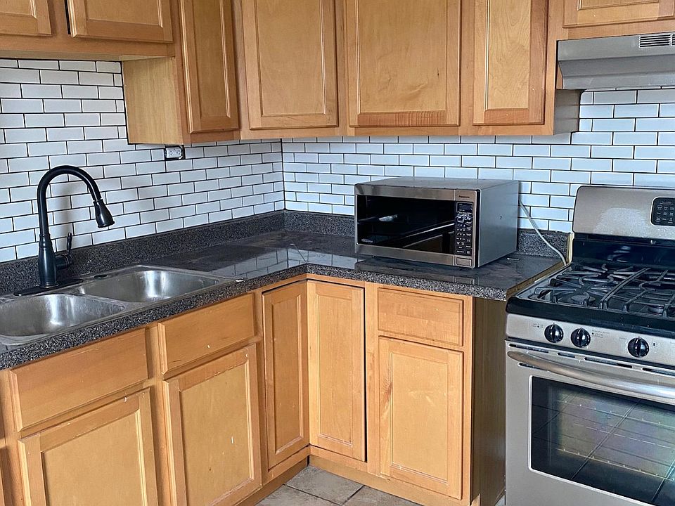 Large kitchen with stainless steel appliances.