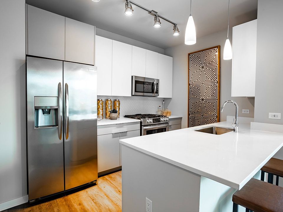 Unit Kitchen with Stainless Steel Appliances and Quartz Countertops at The Grand Central Apartments in Chicago, IL 60607