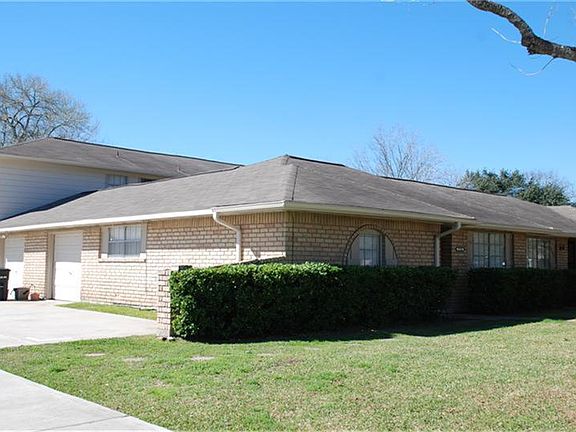 Side view showing drive with entry into 1-car garage.