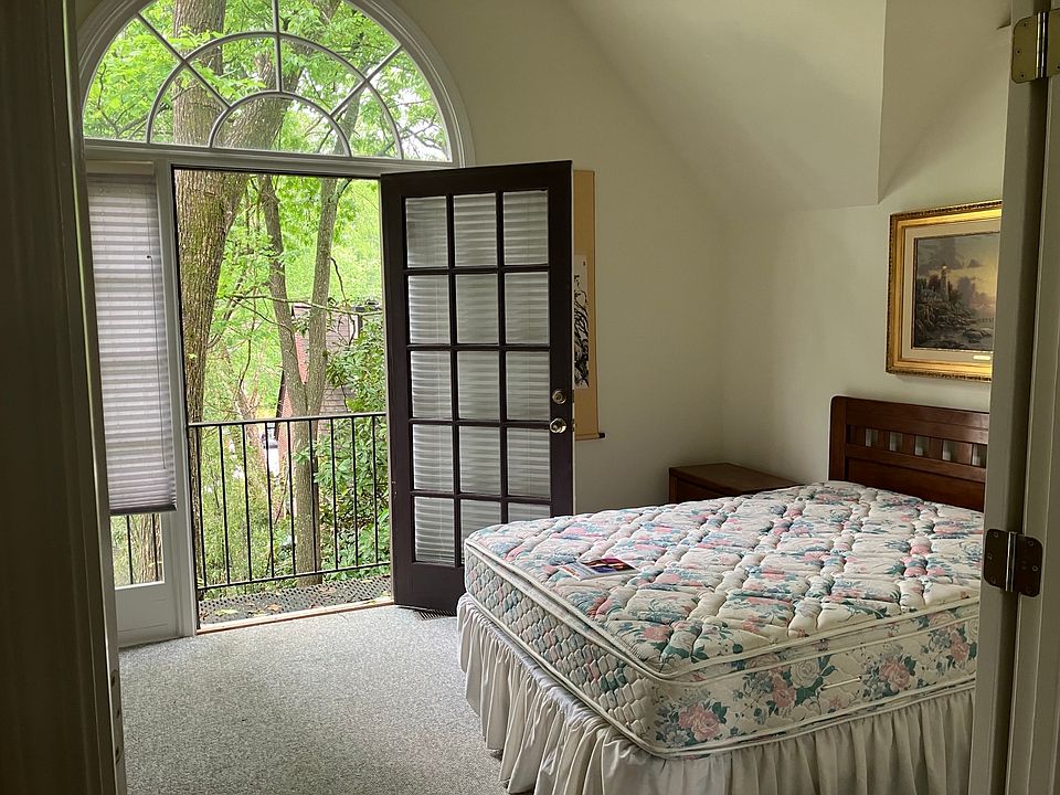 Bedroom overlooks large landscaped garden from balcony