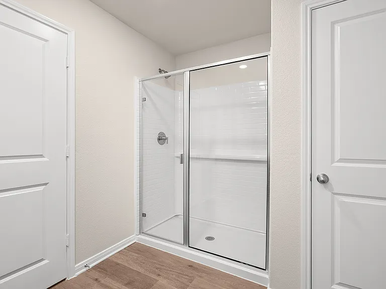The master bathroom has a glass walk-in shower.