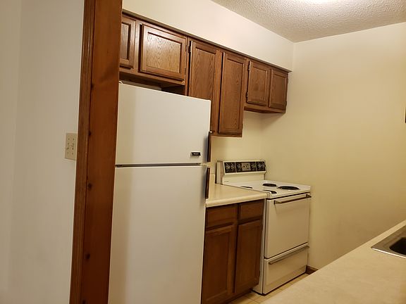 Kitchen showing the electric range and refrigerator