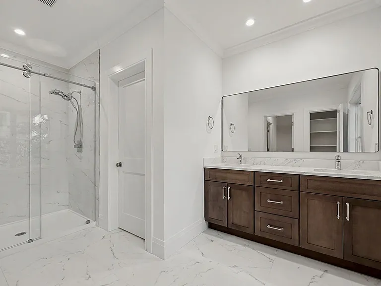 A beautifully appointed luxury bath showcasing a sleek walk-in shower