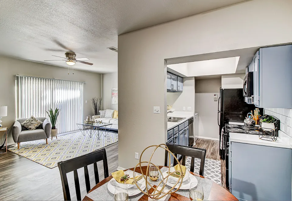 Dining room overlooking kitchen and living room with wood-style flooring