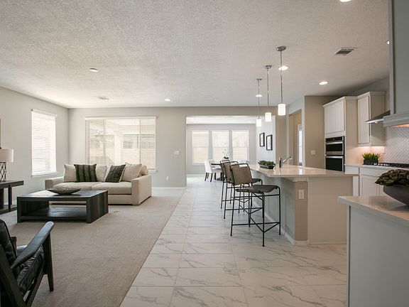 Comfortable carpet separates the gathering room and kitchen dining spaces.