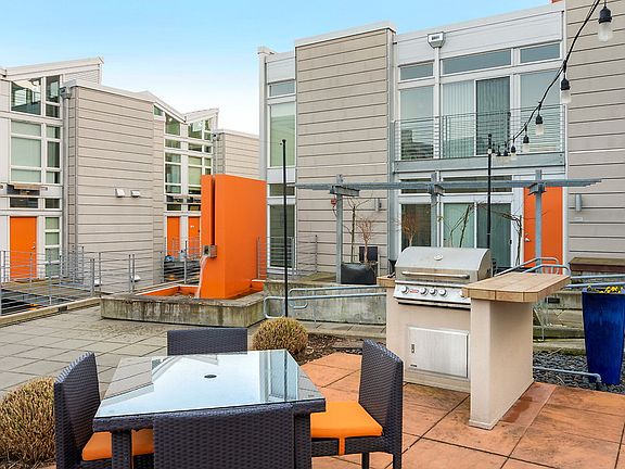 Community courtyard with BBQs, fountain, and lounge seating.