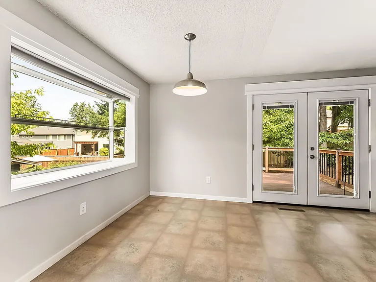 Eating/Dining Area off of the kitchen with garden window overlook backyard. Double doors to exit to composite decking.