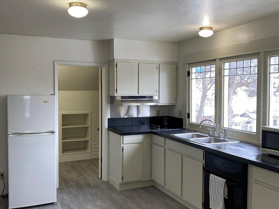 Well lit kitchen with vinyl plank flooring.