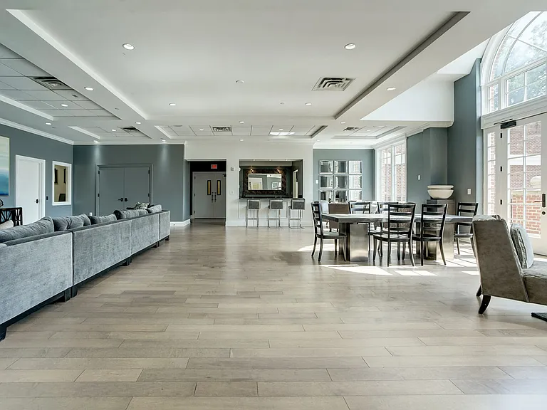 Expansive Resident Clubhouse with Plush Seating Areas, Cozy Fireplace, Balcony Area, and Bar