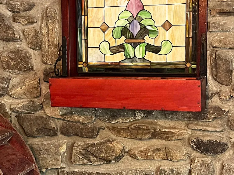 Den are with stained glass in stone wall