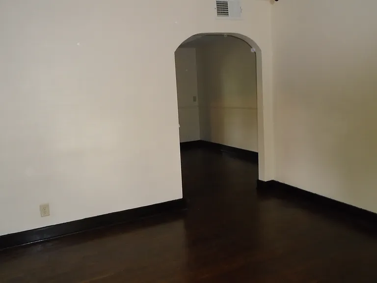 Hardwood floors throughout. Freshly painted walls and large, high arched doorways.