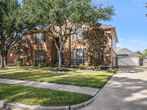 A private gated driveway gate leads to the back yard that has a beautiful back patio & sparkling pool.