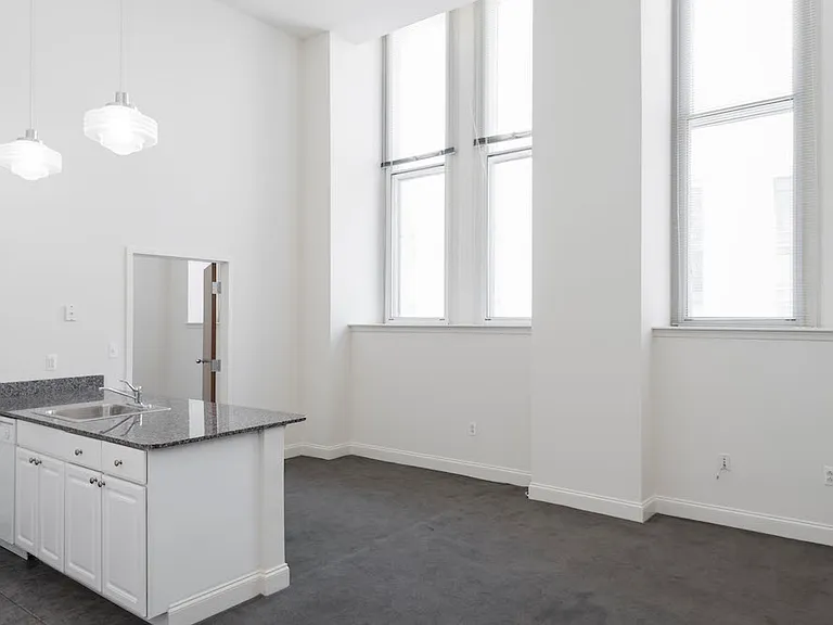 Luminous living and kitchen at Victory Building Apartments