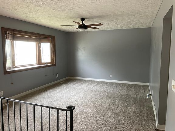 Large living room with bay window and new carpet