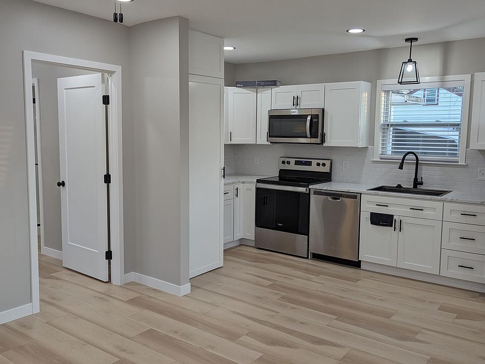 Looking into kitchen from living room corner to the right of entry