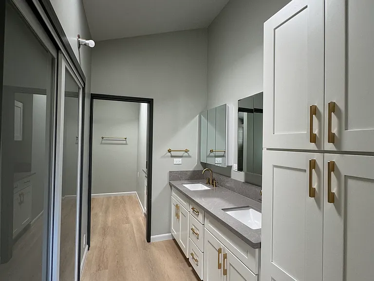 Primary bathroom with lots of storage and walk-in closet.