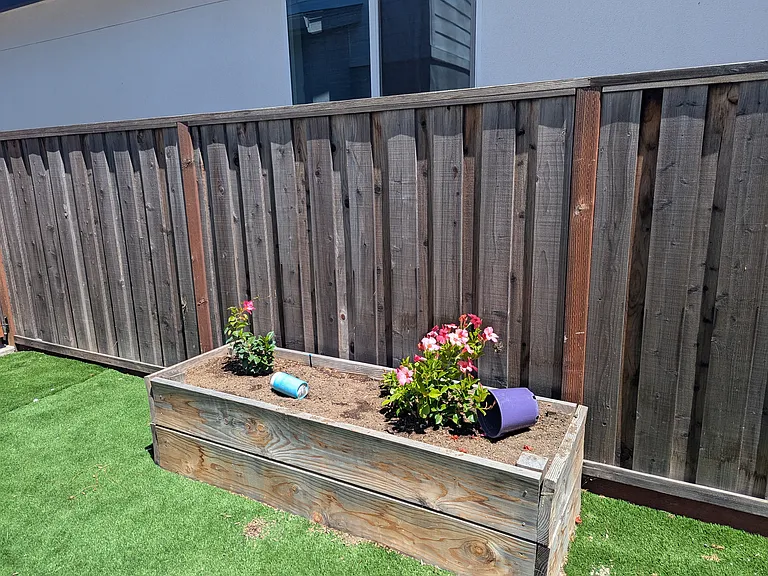 Outdoor area. Artificial grass covers most of the outdoor area. Planters are available if you like gardening.