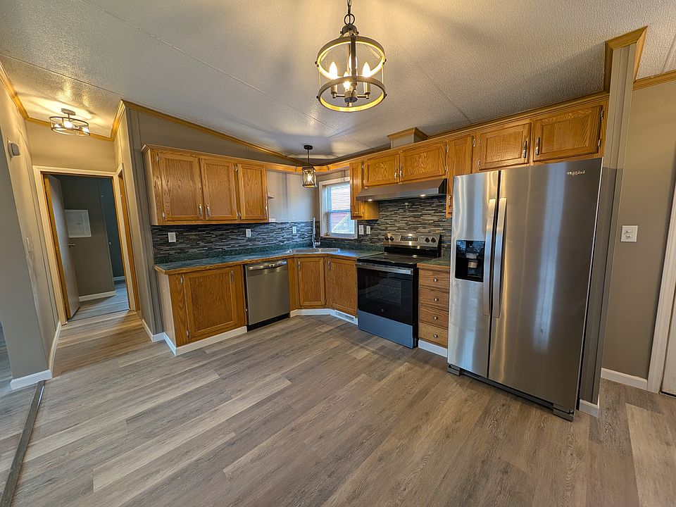 Updated Kitchen with window above sink, stainless appliances, dishwasher, side by side fridge, electric stove with exhaust fan.