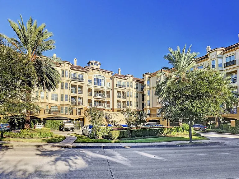 Outdoor view of the building. Guest parking is in the outdoor, uncovered area, and tenant parking is under the building