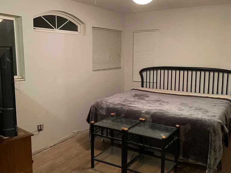 Master bedroom (accommodates up to a king size bed) with private 1/2 bath and access to the backyard.