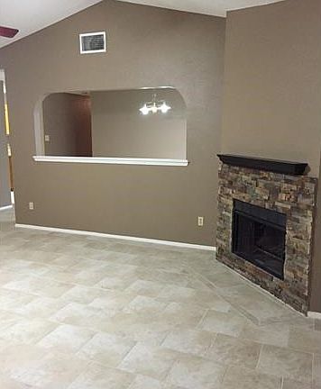 Stone fireplace and pass through living room to dining room