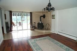 rec room with sliders to deck and river