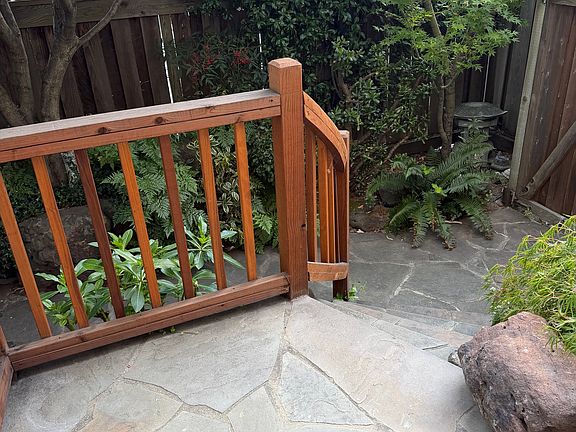 Walkway from living room to maple garden patio with outdoor security camera