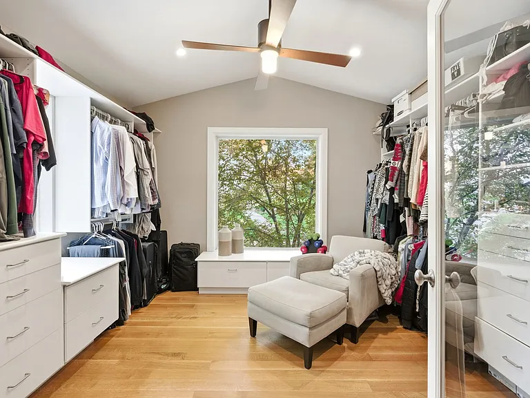 Master bedroom walk-in closet with huge windows facing the backyard.