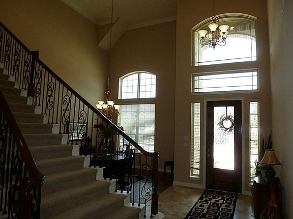 View from the family room toward the entry features Leaded Glass Mahogany front door & Arched Windows in the Entry & Formal Dining.