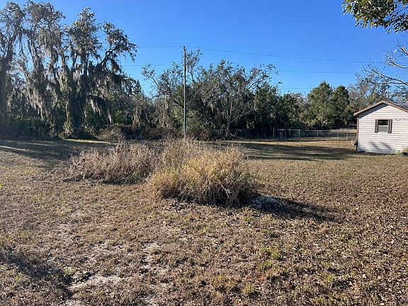 Large yard with fencing and open space.