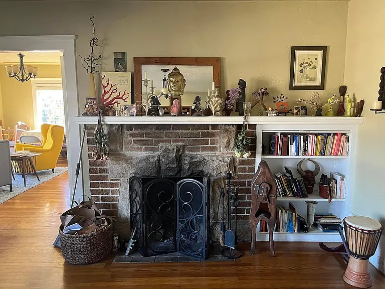Far wall of living room. working fireplace.