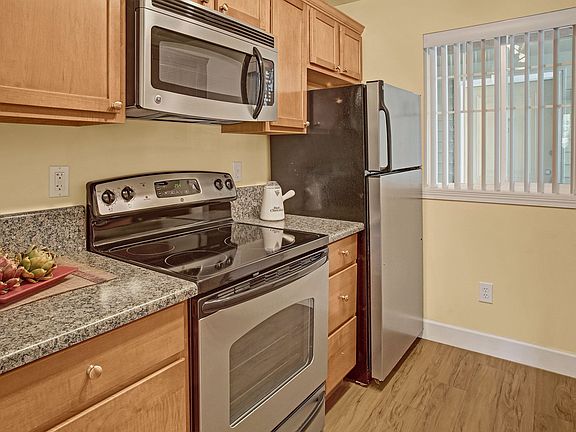 Kitchen with stainless steel oven, stove, refrigerator and microwave