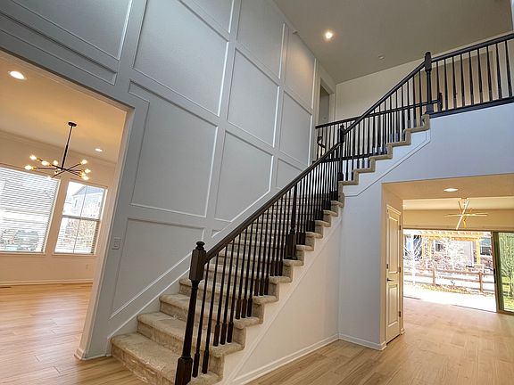 Here is the 2 story foyer, the front door, dining room, stairs to second level. Not shown is also access to single car garage.