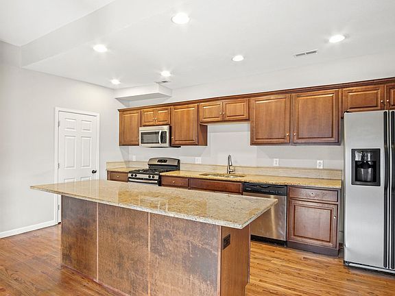 Full Stainless Kitchen, with Gas Range, Microwave, Dishwasher etc. This picture is older and the refrigerator is brand new as of 2020.