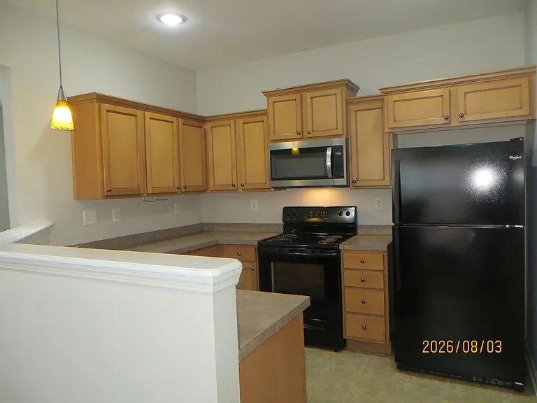 Kitchen opens to dining area and living room.