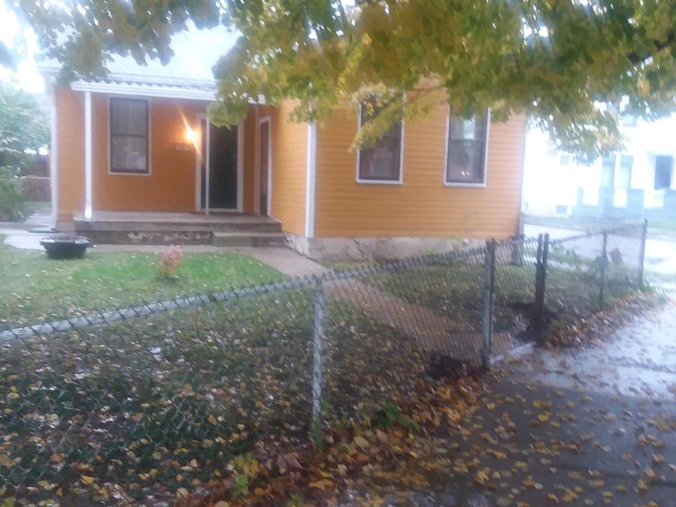 Front entrance With fenced yard and lovely shade tree.
