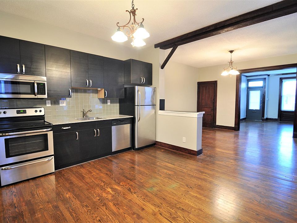 Fully renovated kitchen, looking into the living room and through to the bedroom and front door.