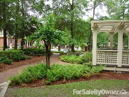 Professional landscaped yard.
						:
						Gunite pool with wrought iron fence leading to pergola and garage