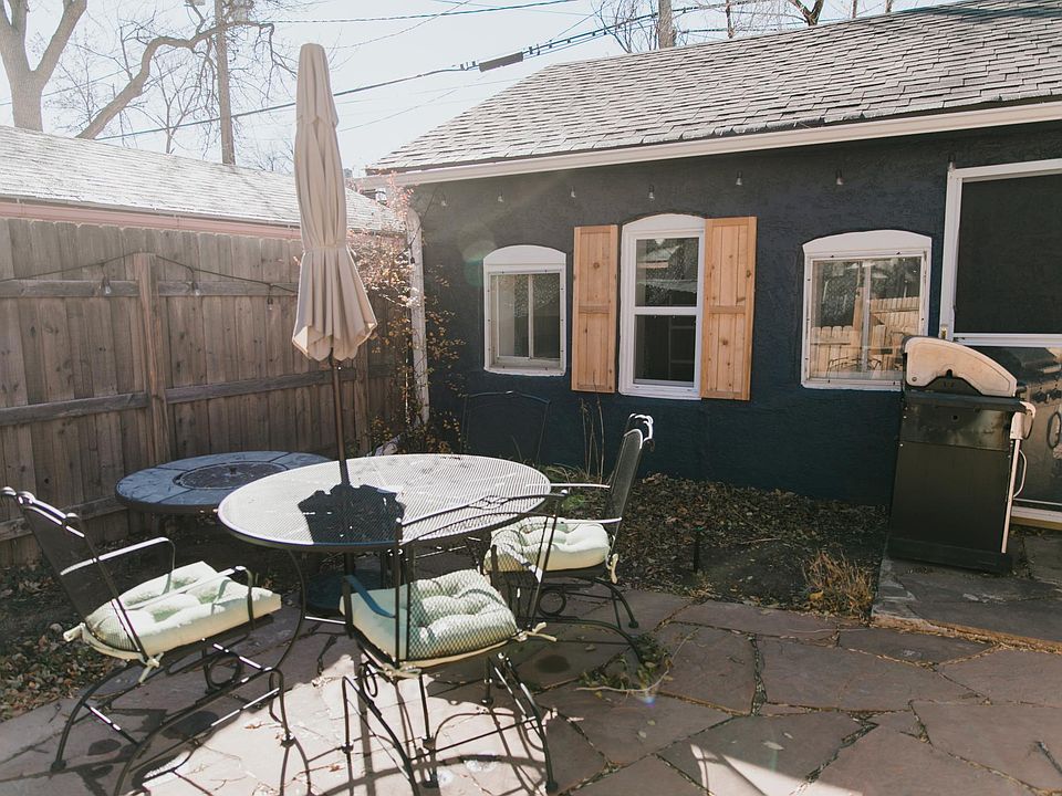 Cottage has a fenced in patio and string lights